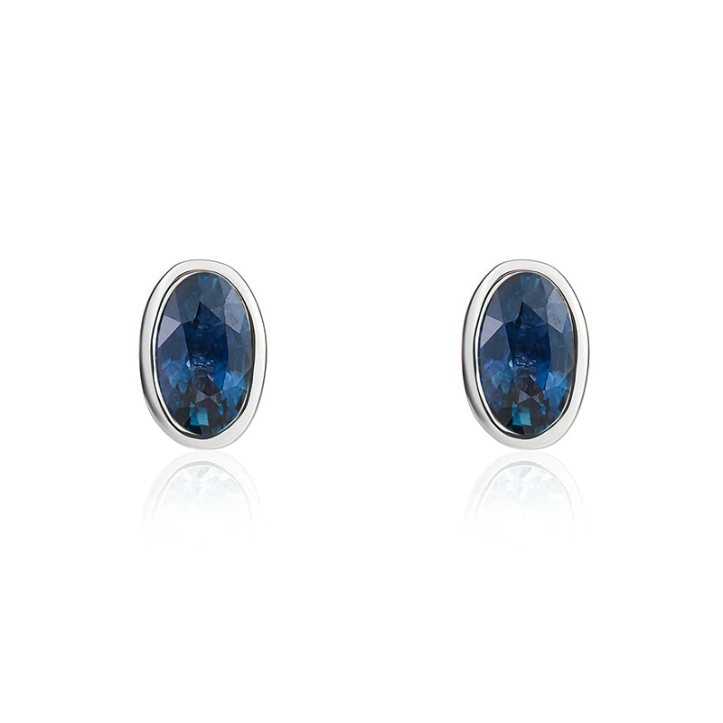 9ct White Gold Sapphire 5x3mm Oval Rub Over Set Stud Earrings