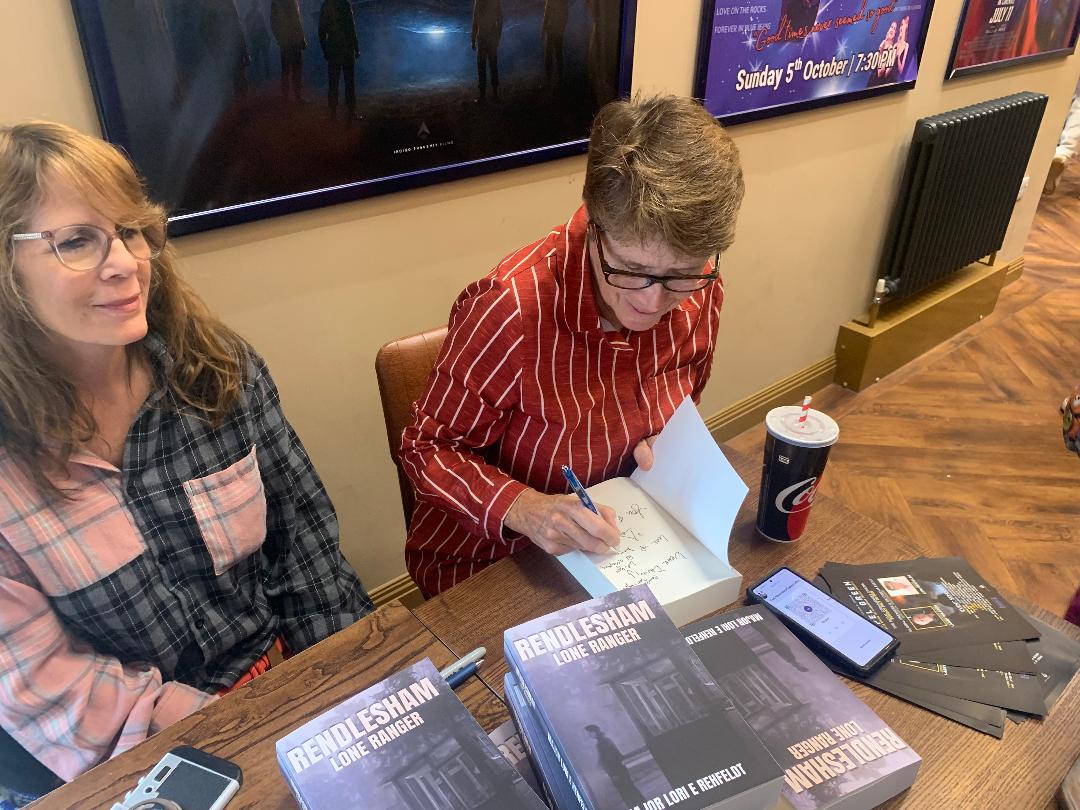 Former U.S. Major Lori E. Rehfeldt signing books 